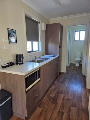 Two Bedroom Cabin - Cambridge | Private kitchen | Full-sized fridge, microwave, stovetop, electric kettle - BIG4 Hobart Airport Tourist Park (Cambridge)