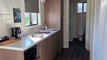 Two Bedroom Cabin - Llanherne | Private kitchen | Full-size fridge, microwave, stovetop, electric kettle
