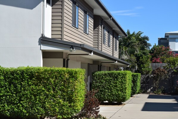 A residential building with a modern design, featuring a flat roof and a covered front porch. - Gladstone Heights Executive Apartments (Gladstone)