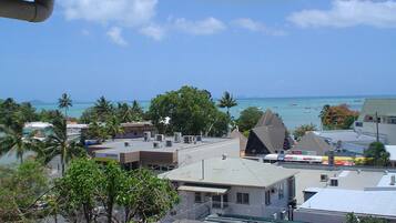 A coastal view with buildings, a clear sky, and the sea.