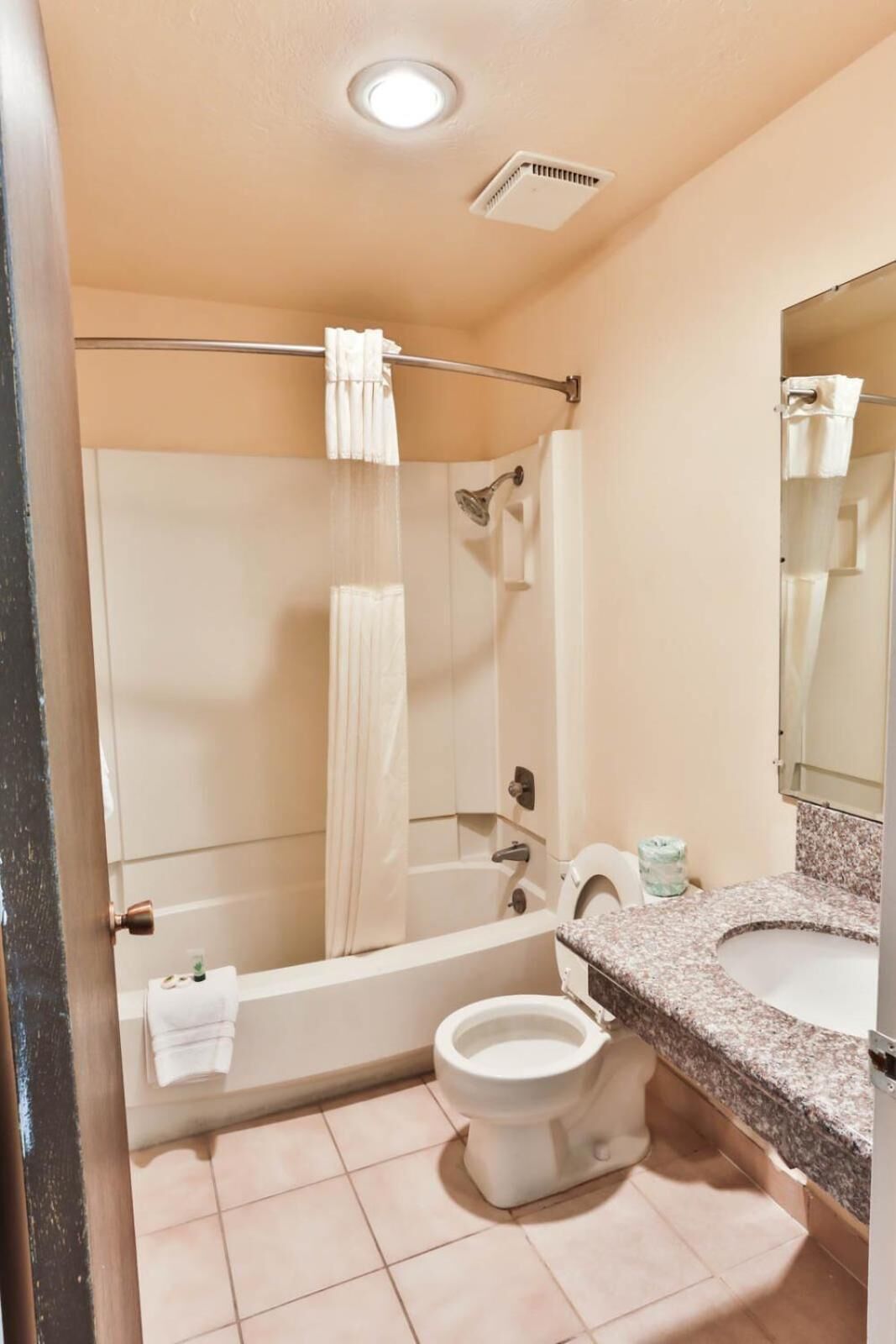 A bathroom with a bathtub, toilet, and sink.