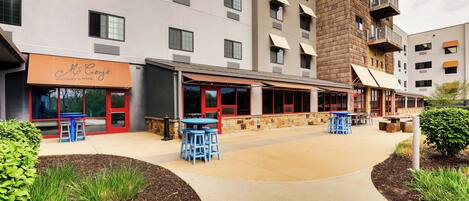 A modern building with a restaurant named "McCoy's" and outdoor seating.