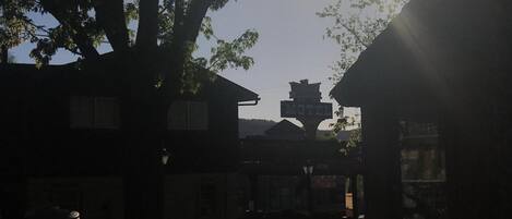 A motel with a signboard, surrounded by trees and a fence.