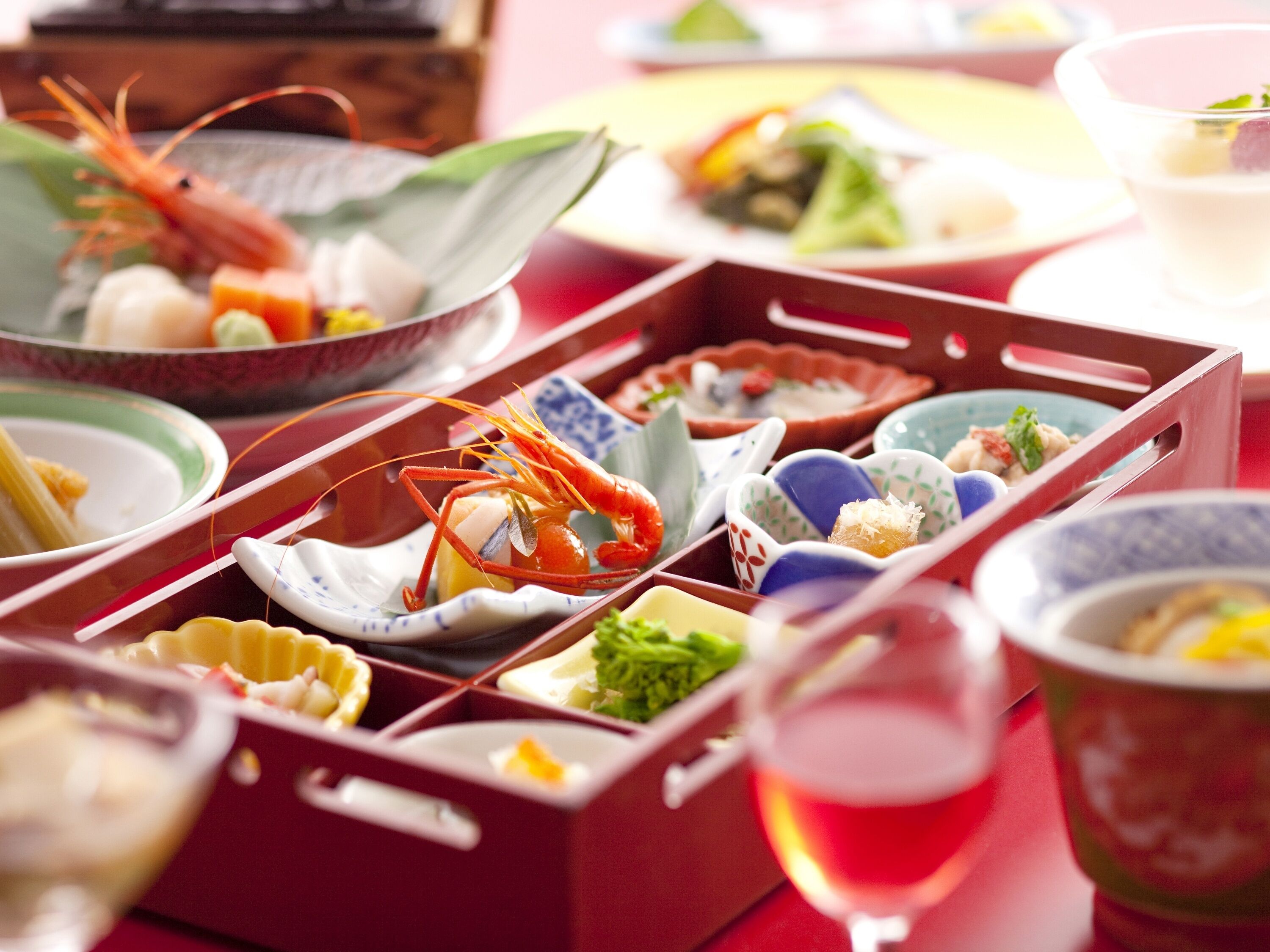 A traditional Japanese meal with various dishes in separate compartments.
