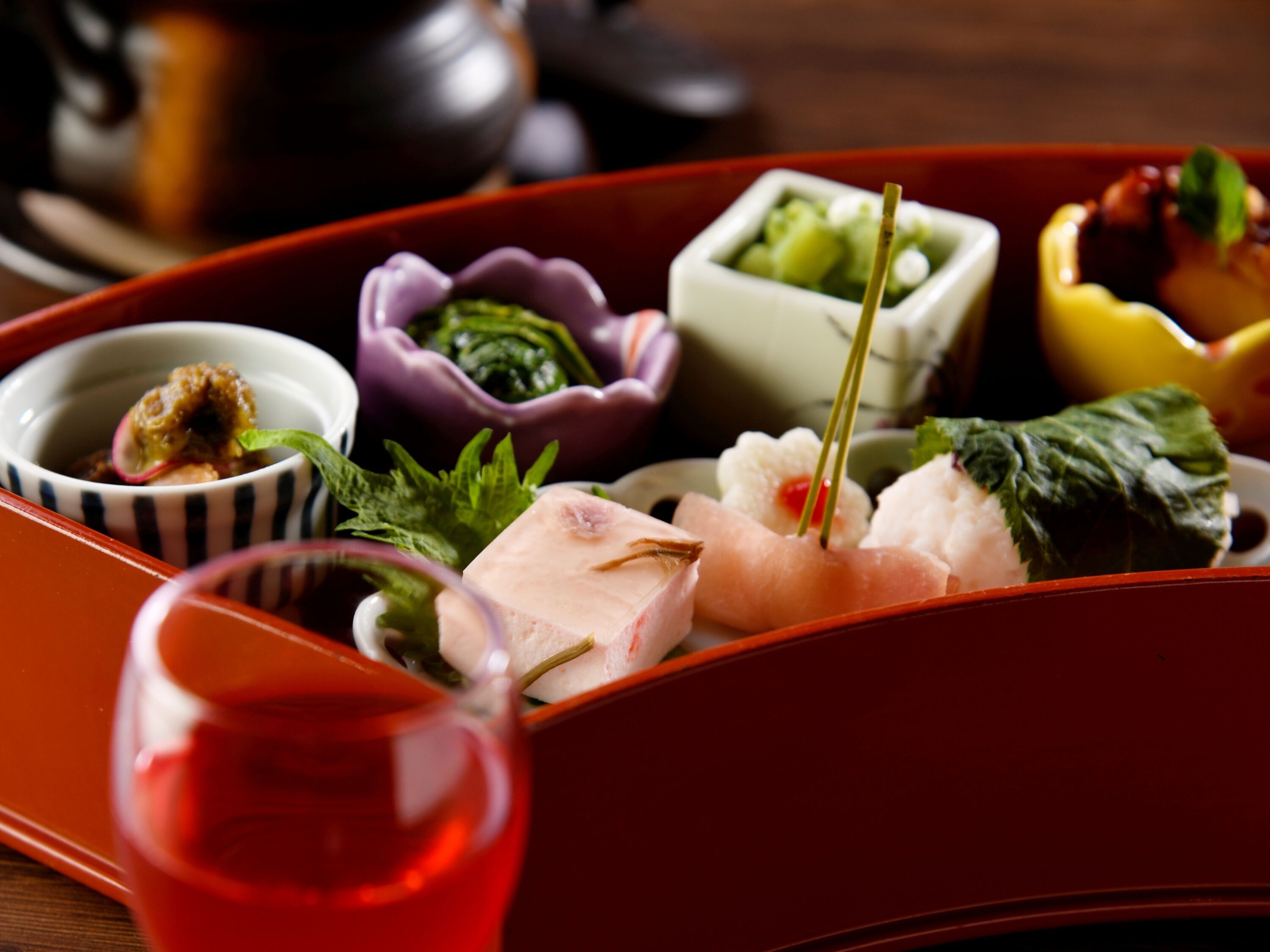 A traditional Japanese bento box with various food items.