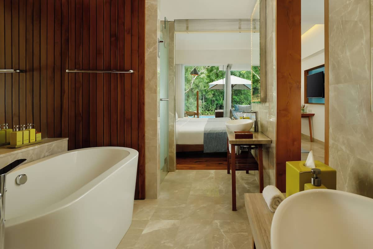A modern bathroom with a bathtub, a sink, and a shower area.