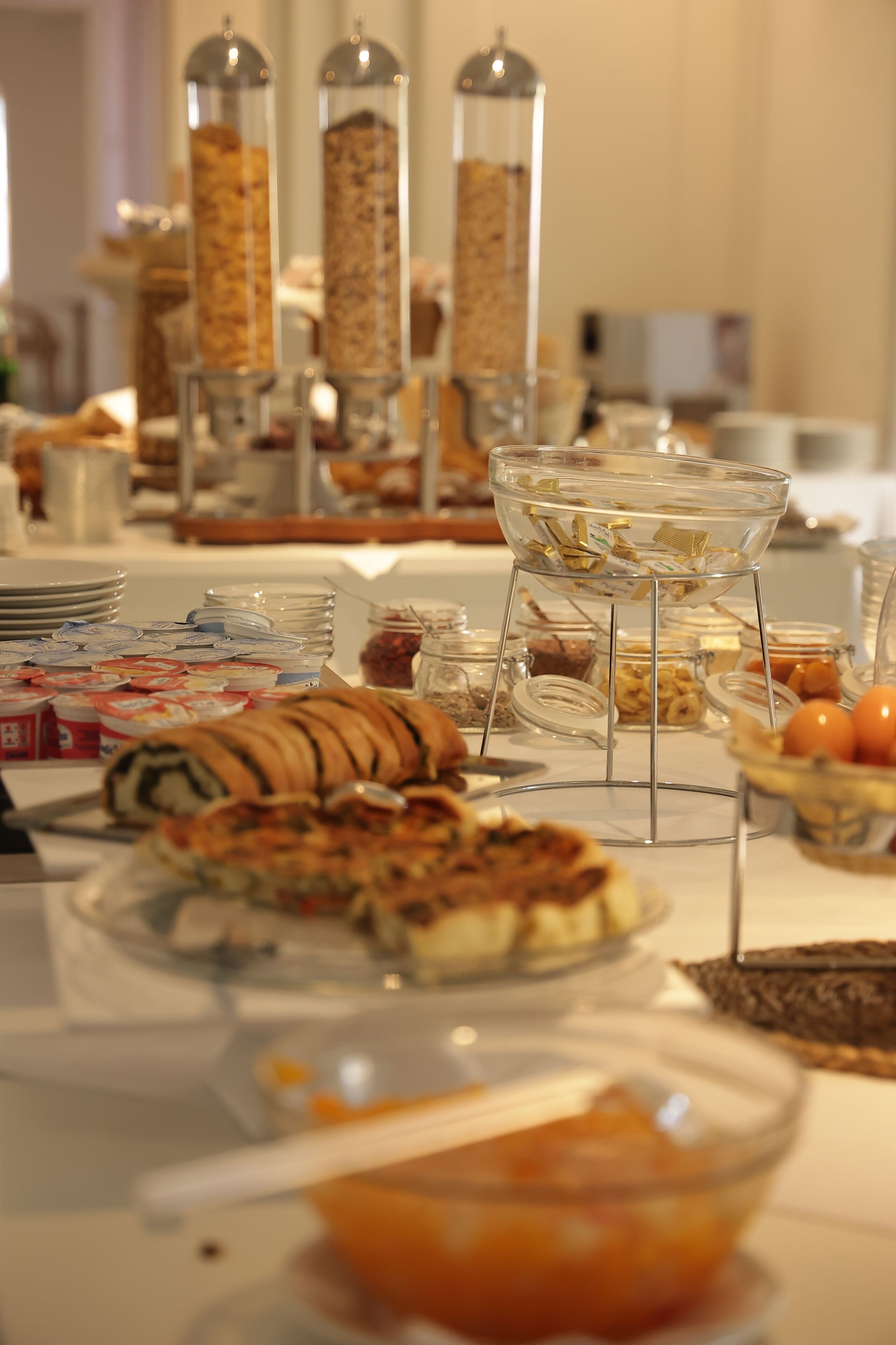 A buffet table with various food items and containers.