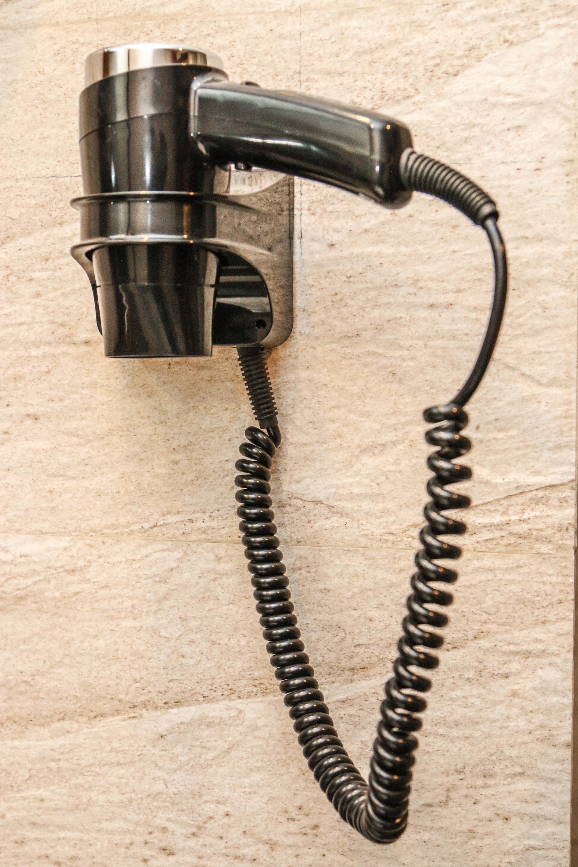A telephone with a coiled cord.