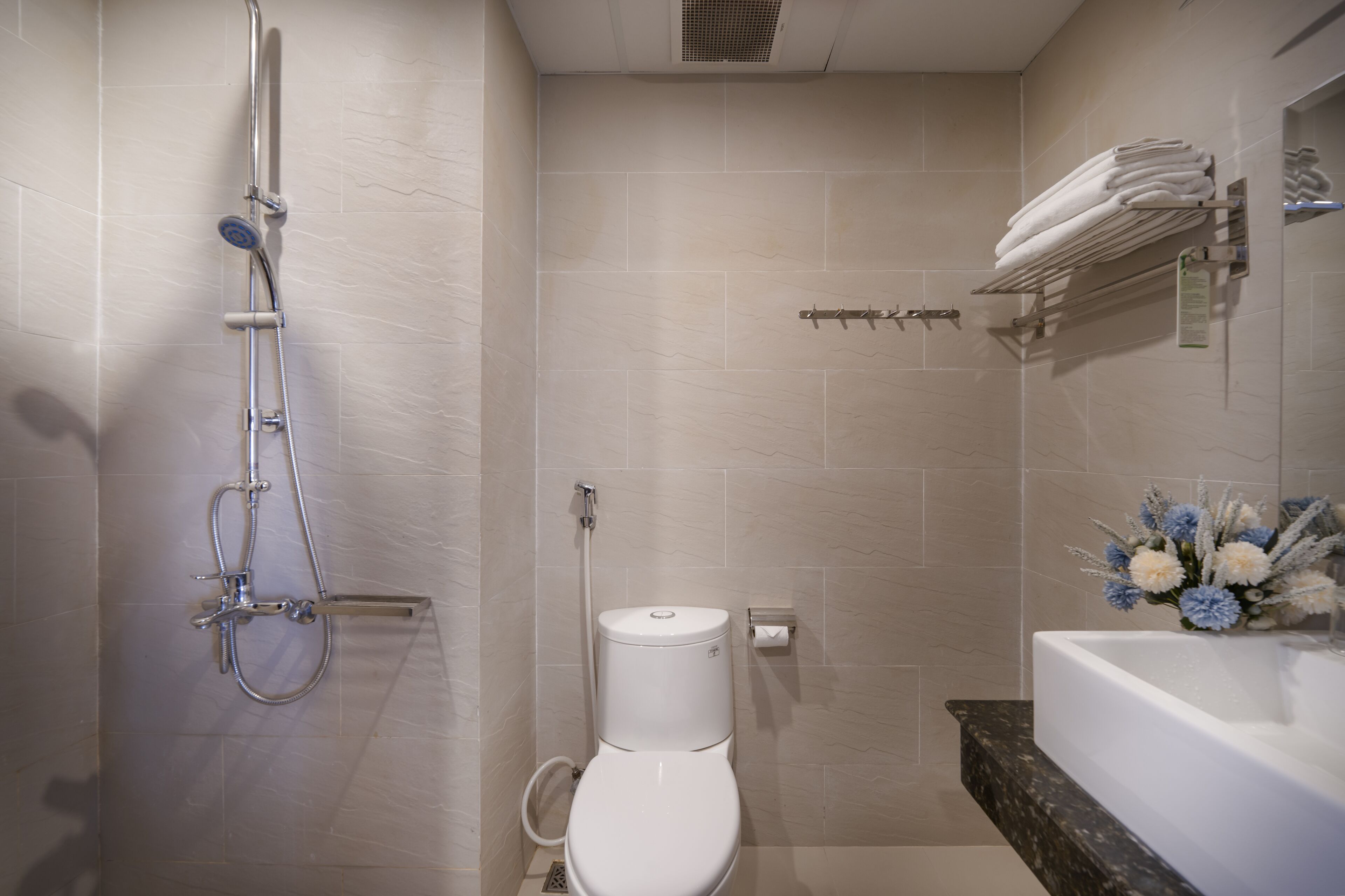 Un baño moderno con ducha, inodoro y lavabo.