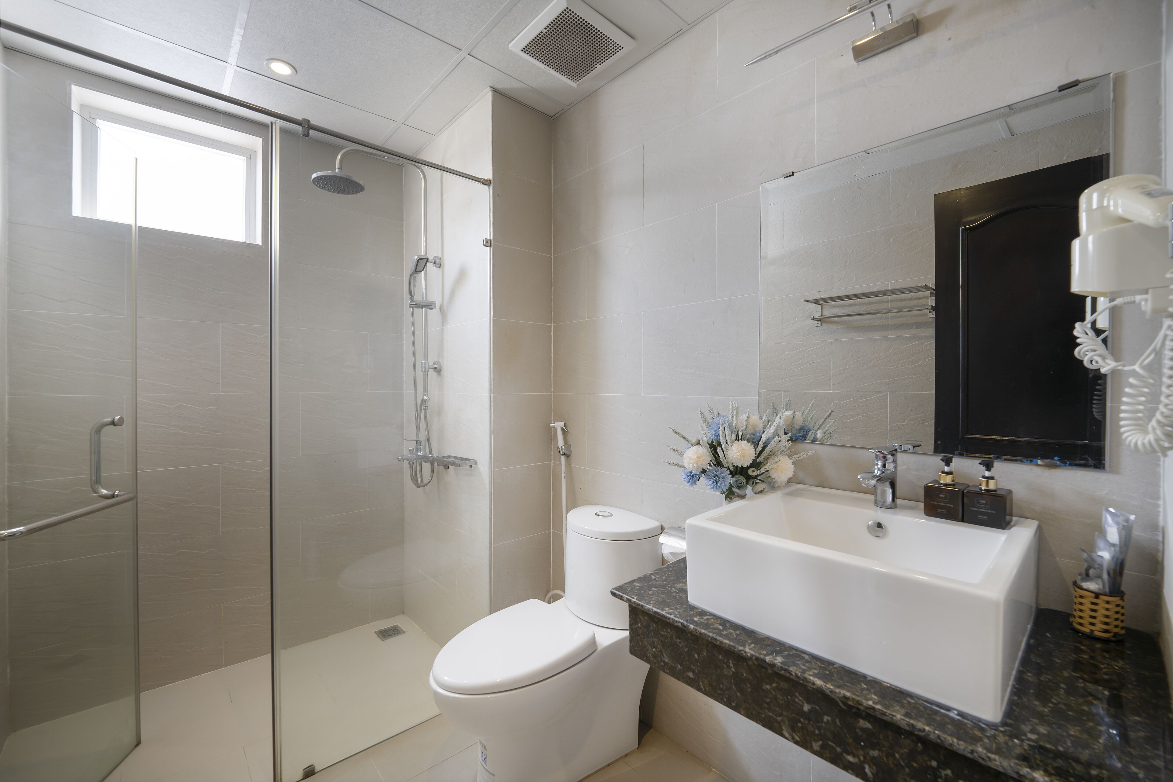 designer toiletries, hair dryer, bathrobes, slippers