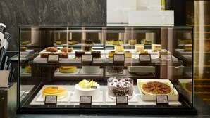 A dessert display case with various cakes and pastries. - Hotel President (Seoul)