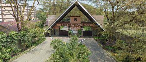 The entrance to Lake Naiyasha Resort with a clear pathway leading to the main building, surrounded by lush greenery.