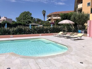 Seasonal outdoor pool, pool umbrellas, pool loungers