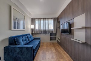 Superior Suite, 1 King Bed | Living area | 29-inch flat-screen TV with cable channels, TV