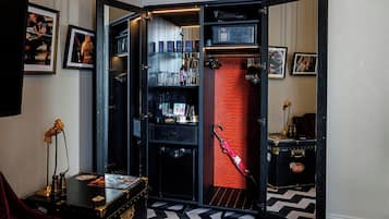 A room with a mirrored wardrobe, a red brick wall, and a black and white patterned floor.