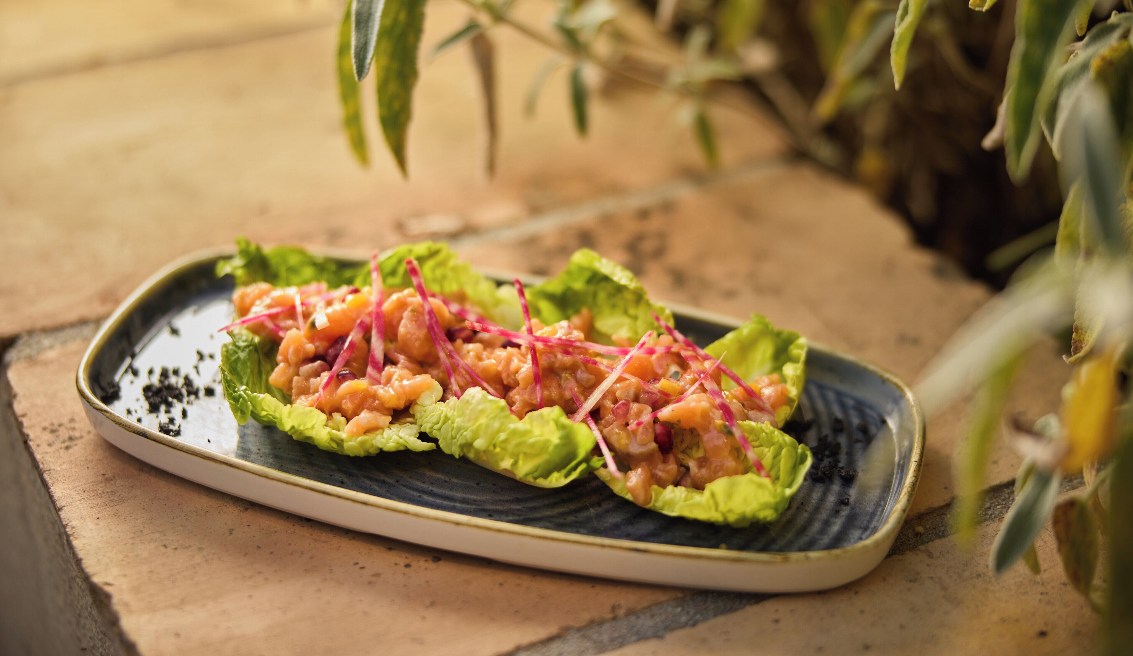 A plate with a salad on a ceramic dish.