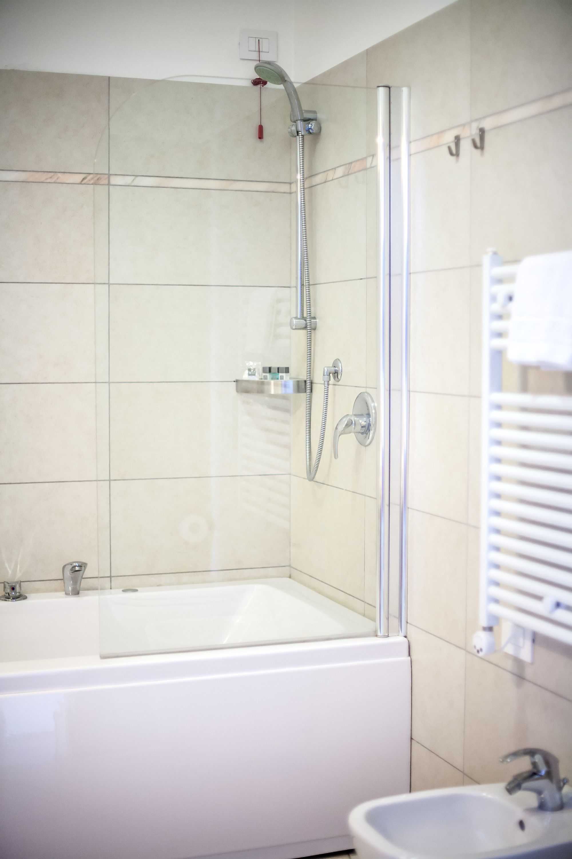 Un baño moderno con ducha de vidrio, bañera independiente y lavamanos.