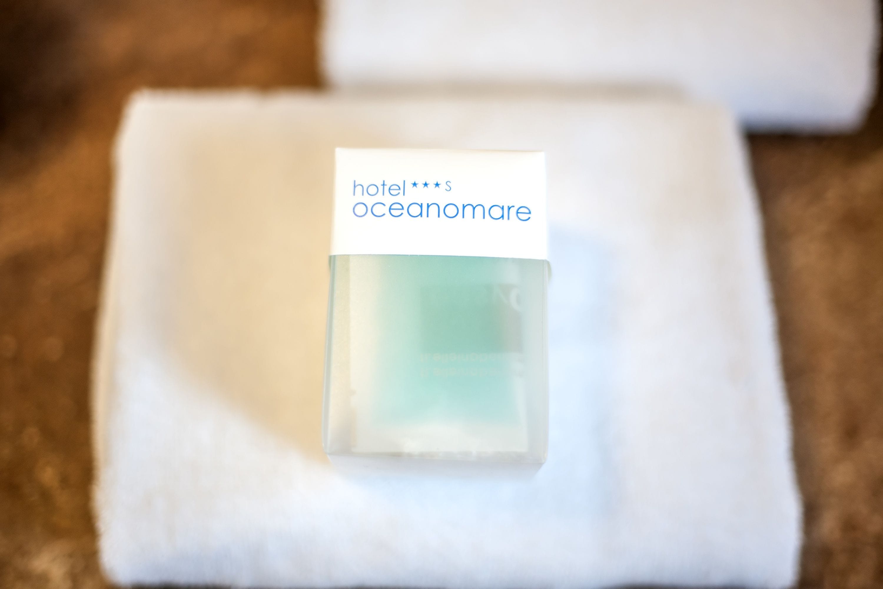 A small, clear bottle with a label on a white surface.