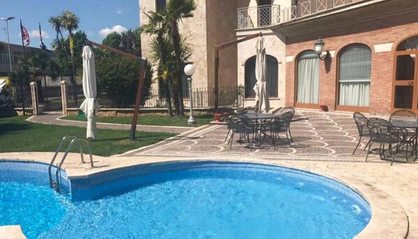 Seasonal outdoor pool, pool umbrellas, pool loungers