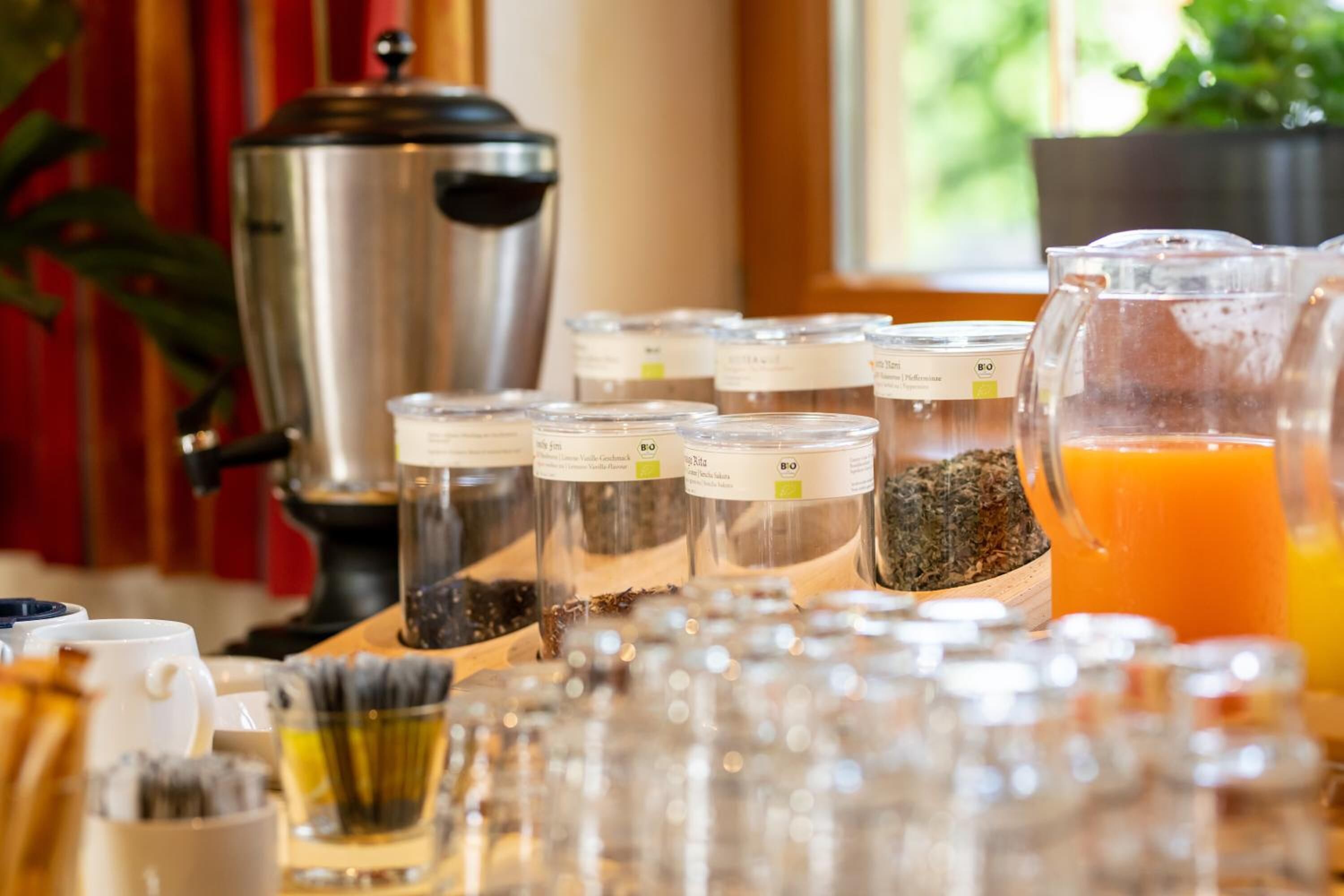 A breakfast buffet with various food items and a coffee maker.