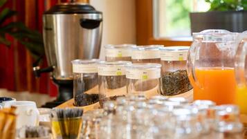 A breakfast buffet with various food items and a coffee maker.