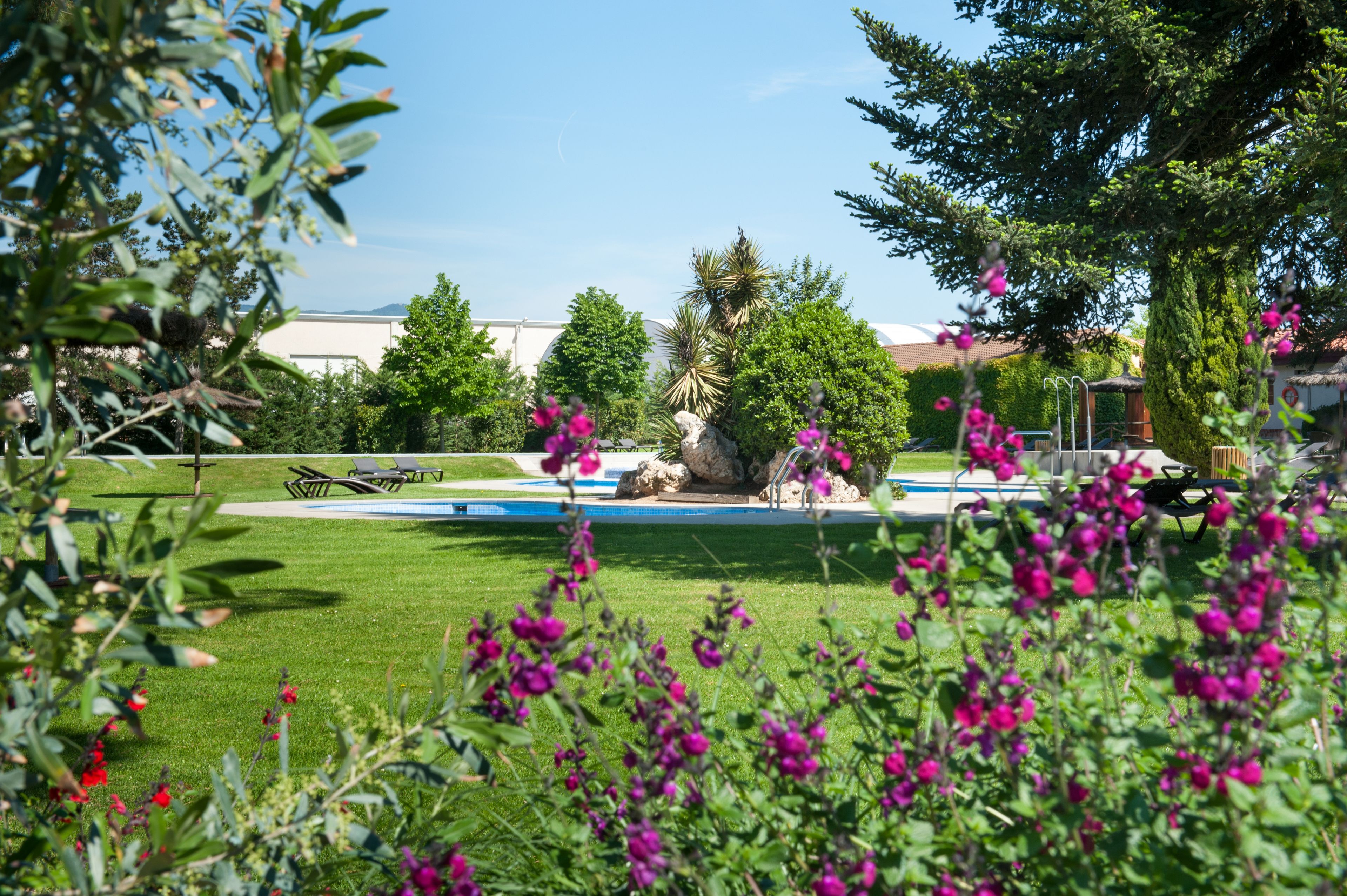 Outdoor pool, open 11 AM to 8 PM, pool umbrellas, pool loungers
