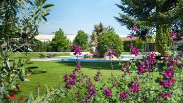 Outdoor pool, open 11 AM to 8 PM, pool umbrellas, pool loungers