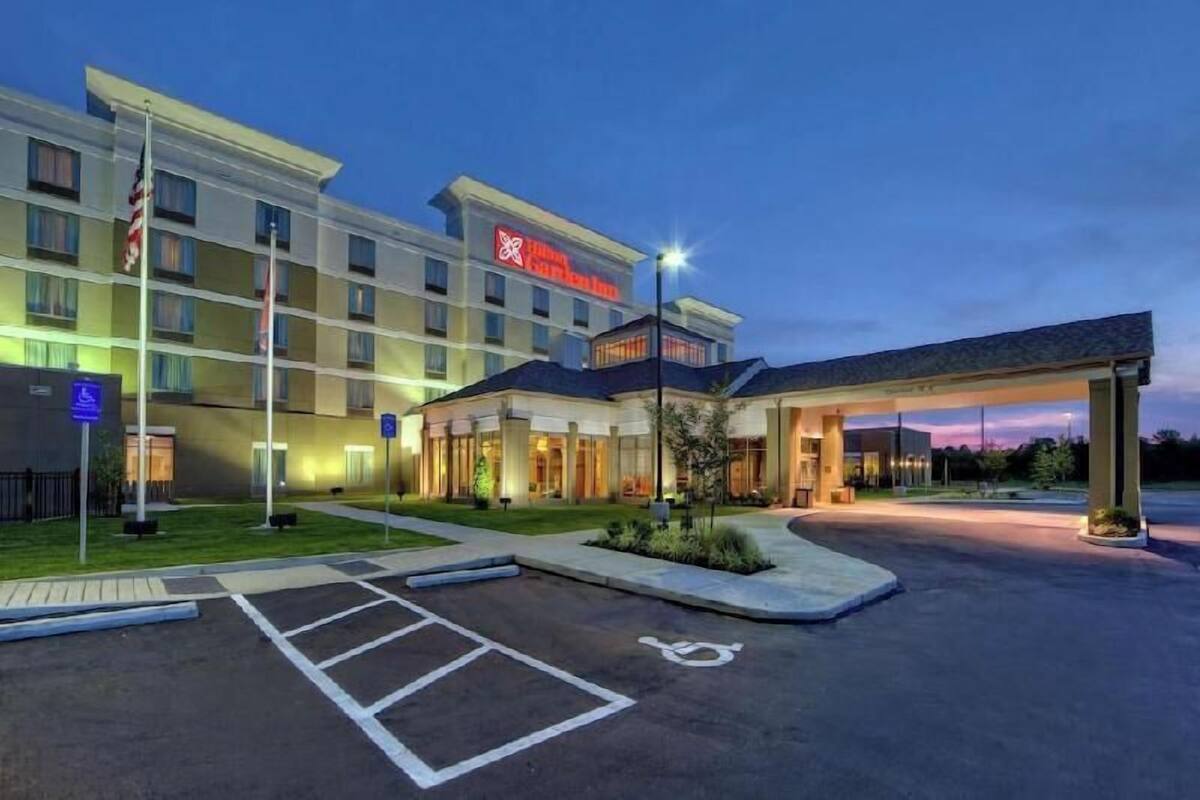 A hotel with a flat-roofed structure, a covered parking area, and a handicap-accessible entrance.