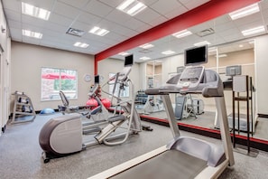 A gym with cardio equipment, weights, and a mirrored wall. - Holiday Inn & Suites Lafayette North by IHG (Lafayette)