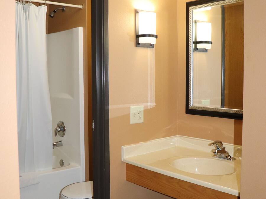 A bathroom with a toilet, sink, and shower.