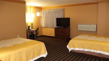 A hotel room with two beds, a desk with a chair, a television, and an air conditioning unit.