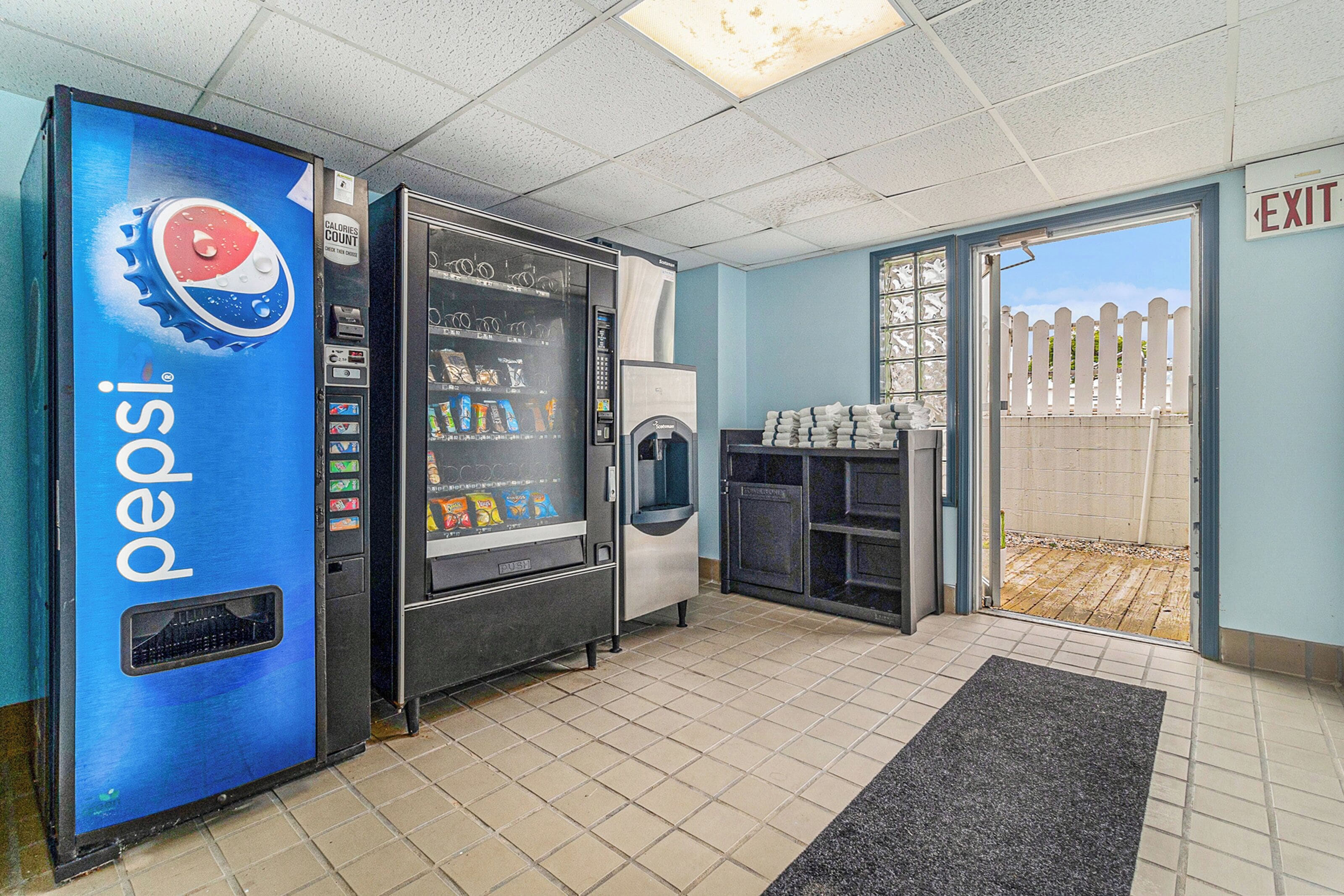 A vending area with a Pepsi machine, a refrigerator, and a water dispenser.