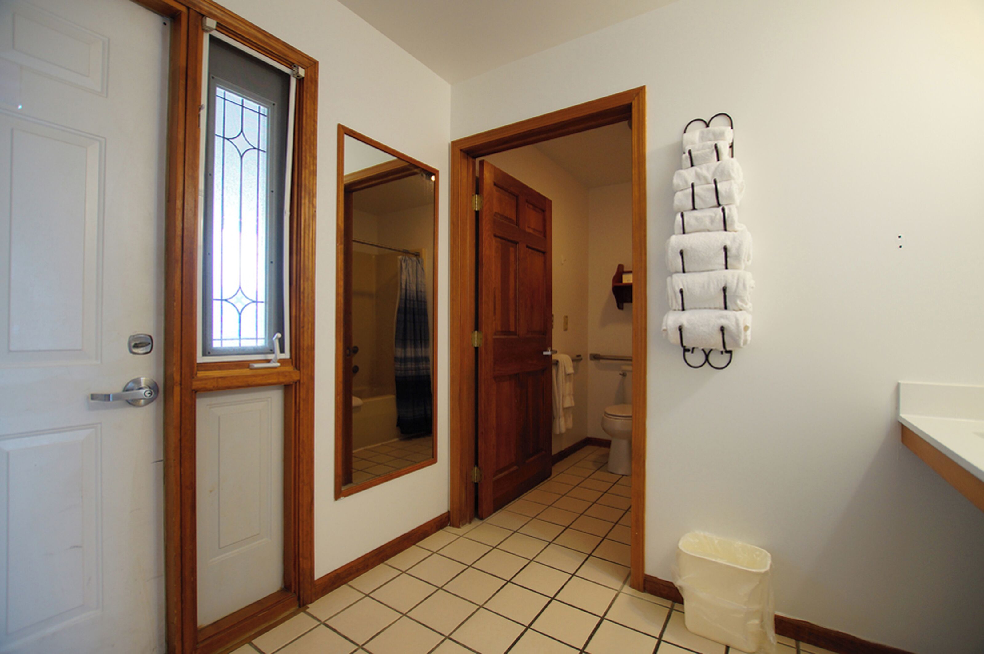 A bathroom with a toilet, a sink, and a mirror.
