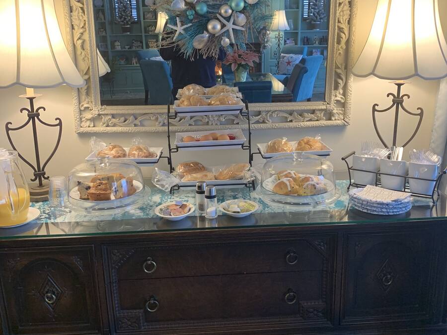 A buffet table with various food items and a decorative centerpiece.
