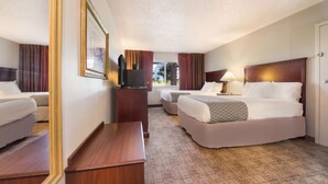 A hotel room with two beds, a desk, a TV, and a large mirror. - SureStay Hotel by Best Western Thomson (Thomson)