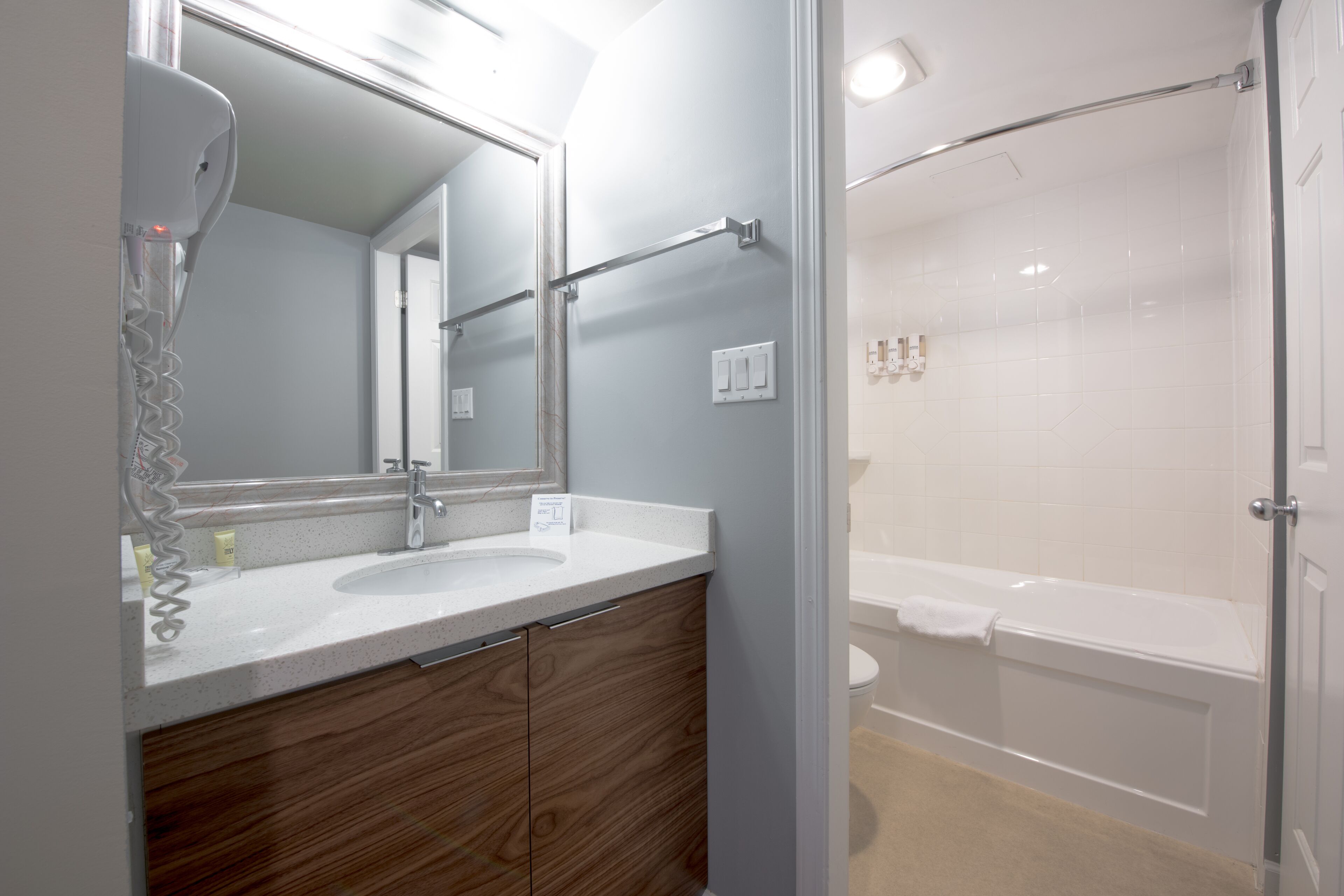 combined shower/bathtub, designer toiletries, hair dryer, towels