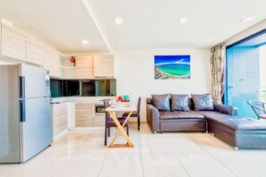 Family Apartment, Partial Ocean View | Living area | 45-inch flat-screen TV with cable channels, TV