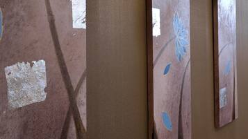 A series of vertical panels with peeling paint and blue leaf patterns.