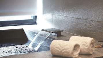 Ett badrum med badkar, handduk och ett fönster.