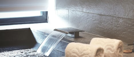A bathroom with a bathtub, a towel, and a window.
