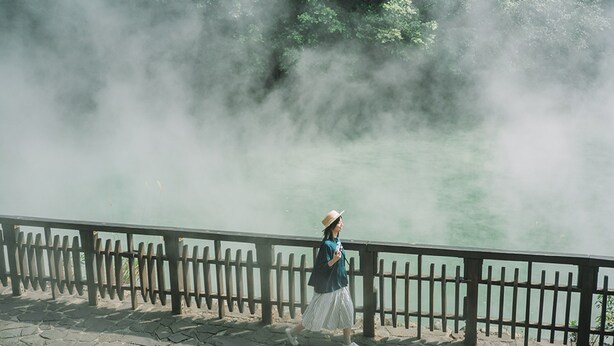 A person standing by a railing with a misty background. - Hotel Royal Beitou (Taipei)