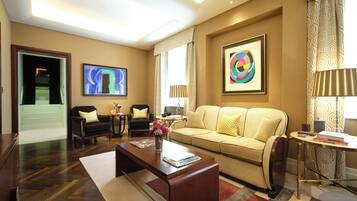 A modern living room with a sofa, coffee table, and artwork on the walls.