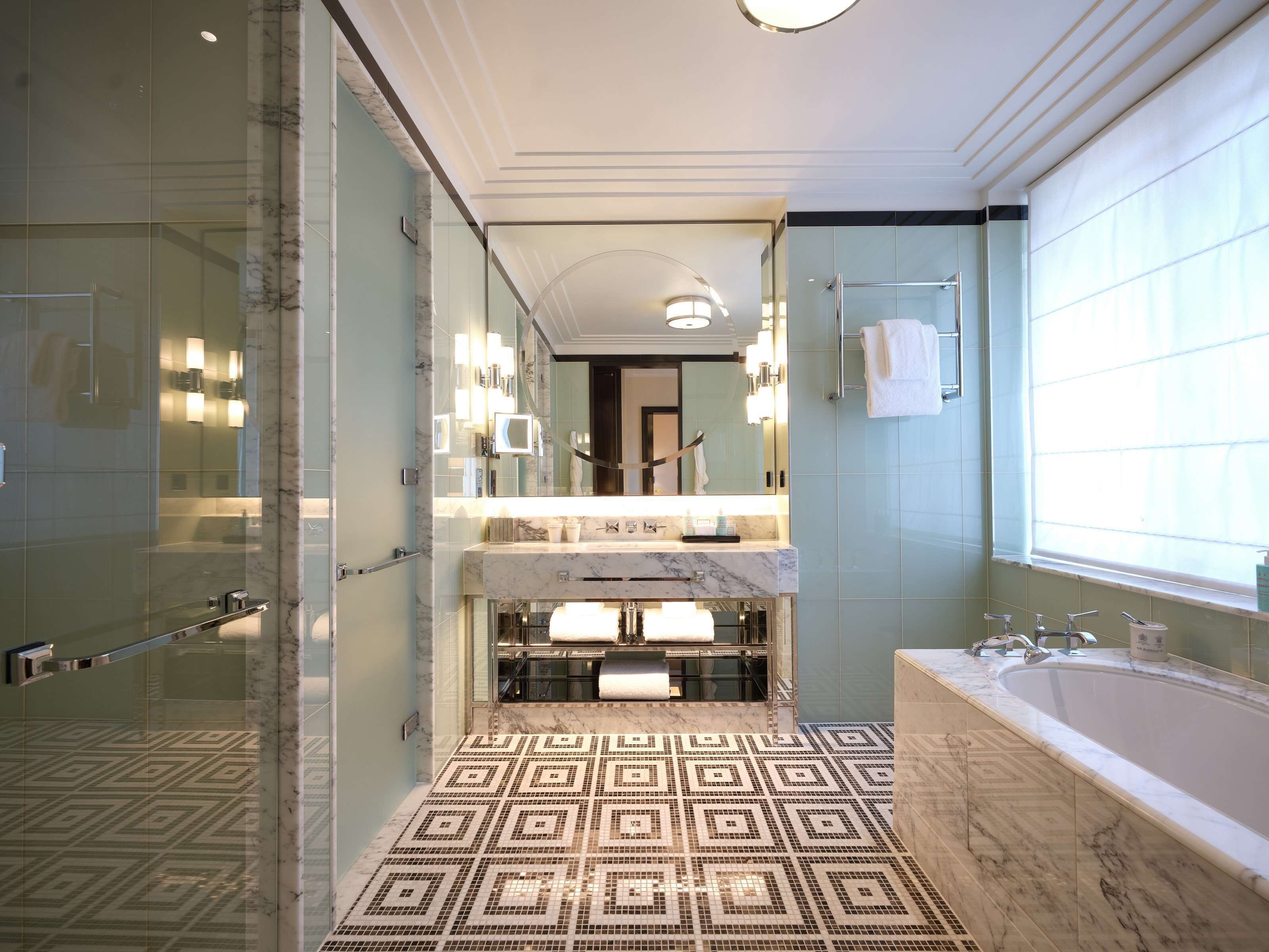 deluxe junior suite | bathroom | rainfall showerhead, designer toiletries, hair dryer, bathrobes