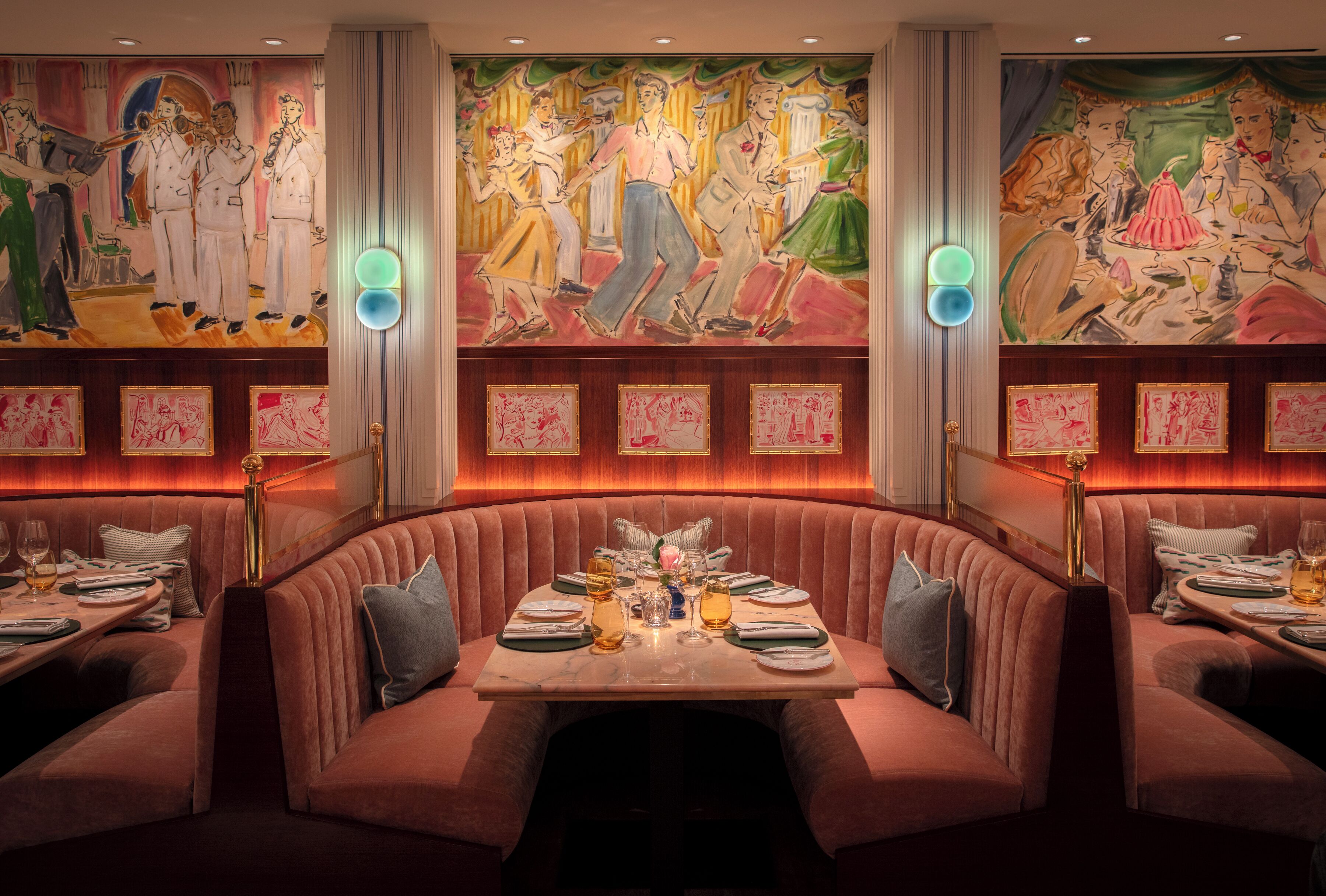 A restaurant with a booth seating arrangement, a mural on the wall, and framed artwork on the walls.