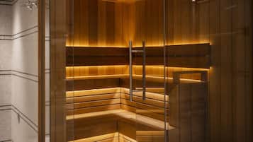 A sauna with wooden benches and a glass partition.