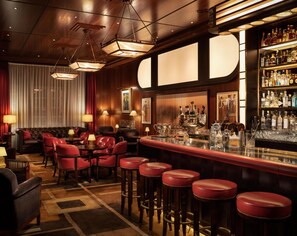 A bar area with a bar counter, stools, and a variety of bottles. - The Beaumont Mayfair (London)
