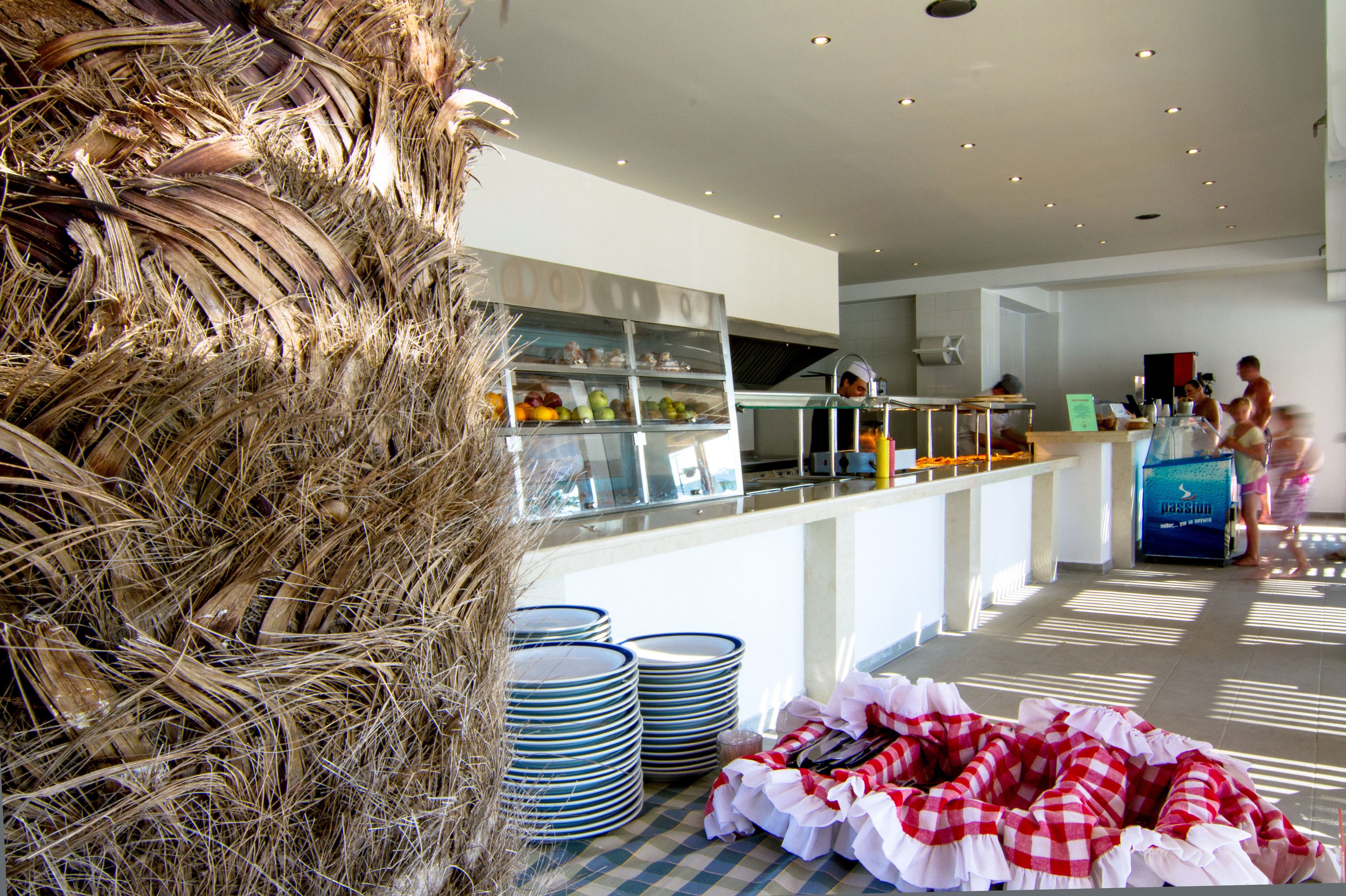 A modern kitchen area with stacked plates and a buffet setup.