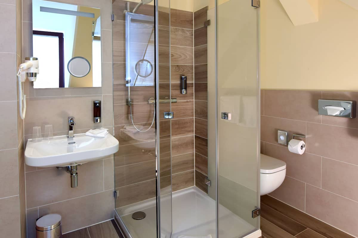 superior apartment | bathroom | shower, hair dryer, slippers, towels