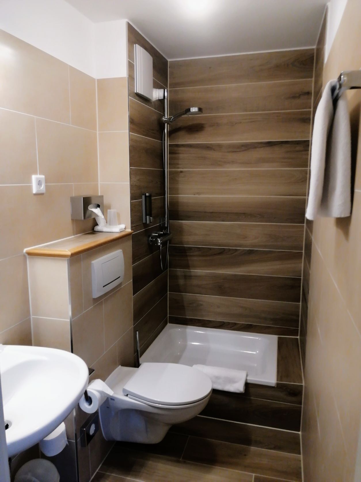 shower, hair dryer, slippers, towels