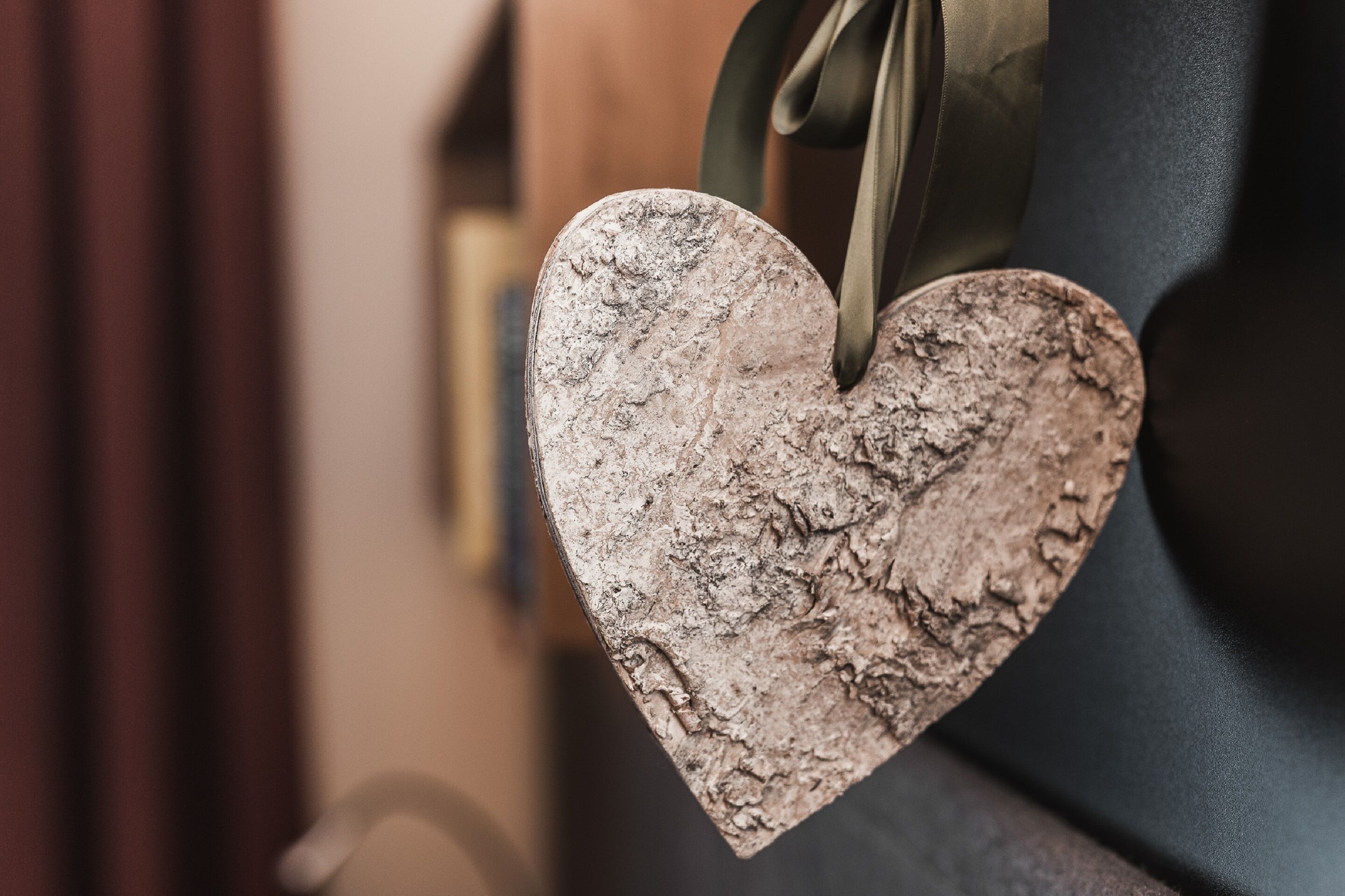 A heart-shaped decoration hanging from a door handle.